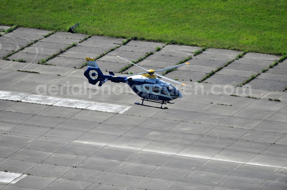 Werneuchen from the bird's eye view: View one just above the runway / runway of the airfield Werneuchen floating Eurocopter with the registration D-HBBZ the Federal Police