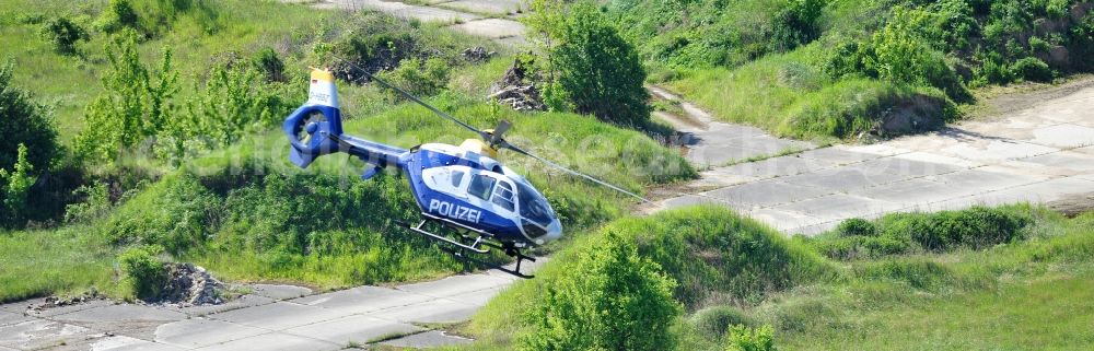 Aerial photograph Werneuchen - View one just above the runway / runway of the airfield Werneuchen floating Eurocopter with the registration D-HBBZ the Federal Police