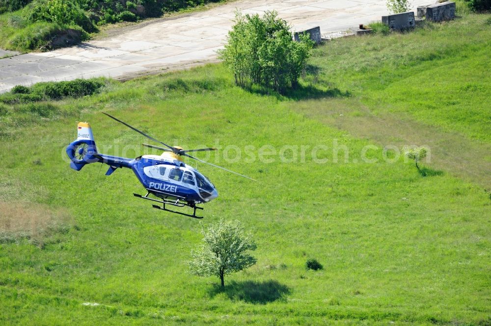 Aerial image Werneuchen - View one just above the runway / runway of the airfield Werneuchen floating Eurocopter with the registration D-HBBZ the Federal Police