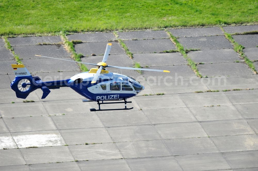 Aerial image Werneuchen - View one just above the runway / runway of the airfield Werneuchen floating Eurocopter with the registration D-HBBZ the Federal Police