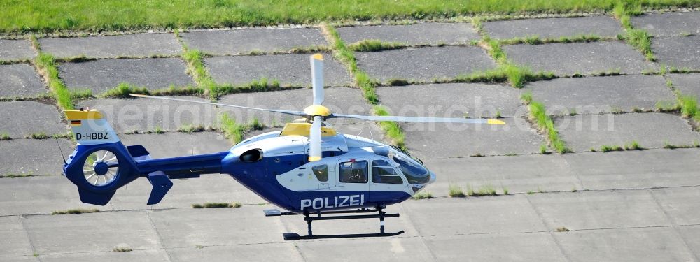 Aerial photograph Werneuchen - View one just above the runway / runway of the airfield Werneuchen floating Eurocopter with the registration D-HBBZ the Federal Police