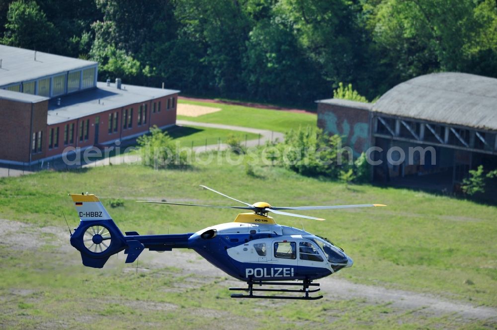 Aerial image Werneuchen - View one just above the runway / runway of the airfield Werneuchen floating Eurocopter with the registration D-HBBZ the Federal Police