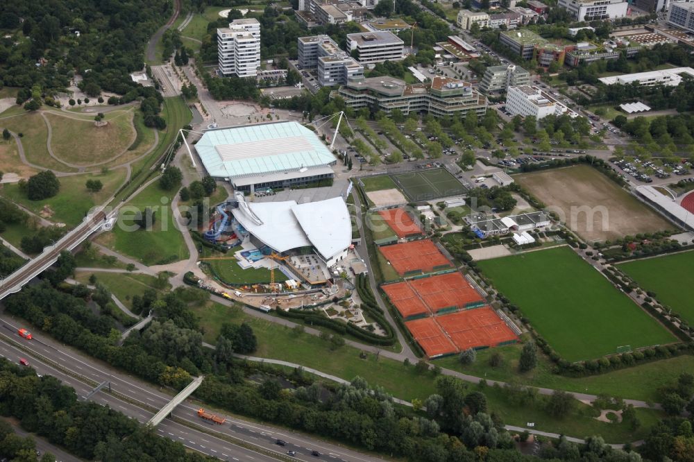 Aerial photograph Karlsruhe - View of the exhibition and event hall Europahalle in Karlsruhe in Baden-Württemberg. The Europahalle consists of a main hall divided in four pieces witha total capacity of 9000 sats, a running track and athletic areas. The roof engeneering is held by two steel cables. Adjacent to the Europahalle lies the Europabad, a swimming and spa hall