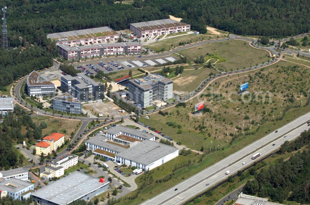 Aerial photograph Kleinmachnow - Blick auf den Europarc nahe der Waldsiedlung Dreilinden bei Kleinmachnow. Dreilinden ist die Bezeichnung eines Forstes und einer Kolonie bekannt für die Grenzübergangsstelle Drewitz. Der Europarc ist ein Gewerbepark auf dem ehemaligen Gelände der wichtigsten Transitstrecke nach Westen und Süden (Checkpoint Bravo). Bekannt sind hier unter an derem eBay Deutschland, mobile.de und Harley-Davidson sowie weitere kleinere Firmen und zwei Hotels. Die Arbeiten begannen 1990 und bis heute ist der Park bei weitem nicht ausgelastet. Weitere Europarcs gibt es in Frankreich und Spanien. Kontakt: Europarc GmbH, Albert-Einstein-Ring 1, 14532 Kleinmachnow / Dreilinden, Walter Brümmer, Tel.: 030/21733100.