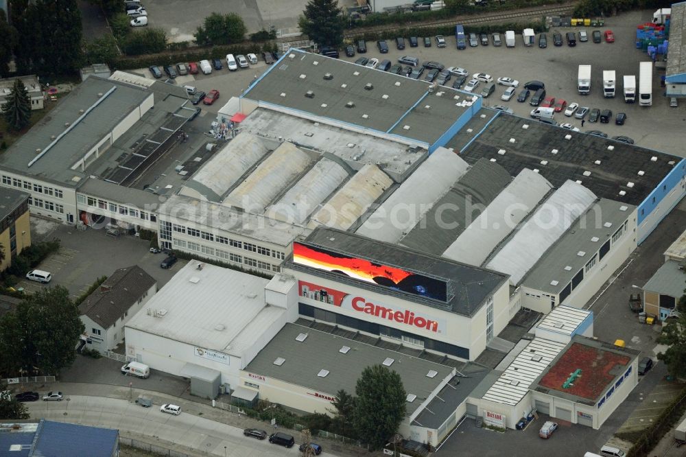 Aerial photograph Berlin - European headquarters of the Energy- and Battery production company Camelion Batterien GmbH in Berlin in Germany. The company and factory building is located in an industrial area on Grenzallee. It is widely visible because of the luminous advertising