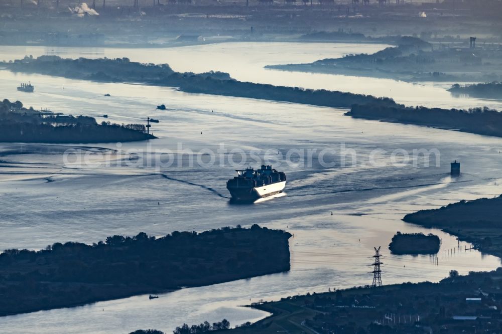 Aerial image Drochtersen - Sailing container ship auf of Elbe in Sonnenaufgang in Drochtersen in the state Lower Saxony, Germany