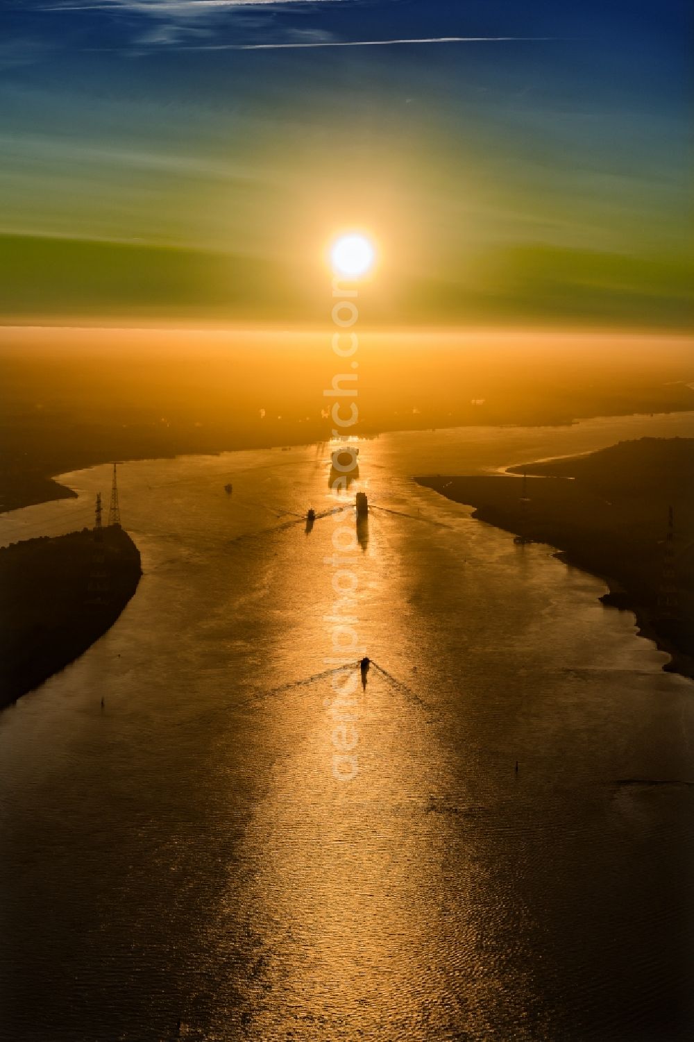 Drochtersen from above - Sailing container ship auf of Elbe in Sonnenaufgang in Drochtersen in the state Lower Saxony, Germany