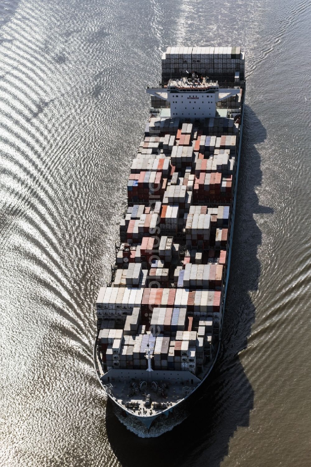 Wedel from the bird's eye view: Sailing container ship auf of Elbe in Wedel in the state Schleswig-Holstein, Germany