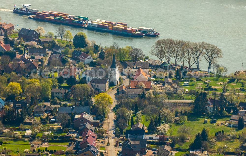 Voerde (Niederrhein) from above - Sailing container ship on the river course of the Rhine in Voerde (Niederrhein) in the state North Rhine-Westphalia, Germany