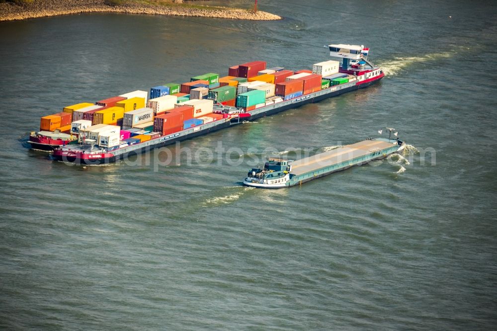 Voerde (Niederrhein) from the bird's eye view: Sailing container ship on the river course of the Rhine in Voerde (Niederrhein) in the state North Rhine-Westphalia, Germany