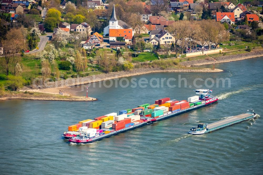 Aerial image Voerde (Niederrhein) - Sailing container ship on the river course of the Rhine in Voerde (Niederrhein) in the state North Rhine-Westphalia, Germany