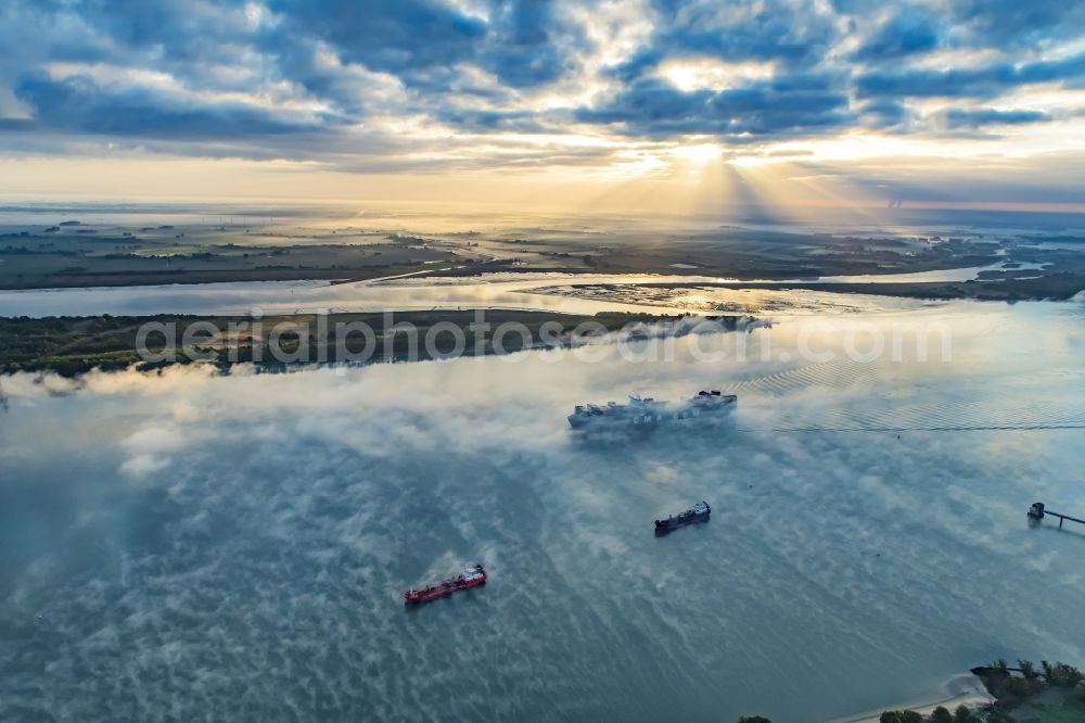 Aerial image Drochtersen - Sailing container ship in fog Layer on Elbe river course in Drochtersen in the state Lower Saxony, Germany