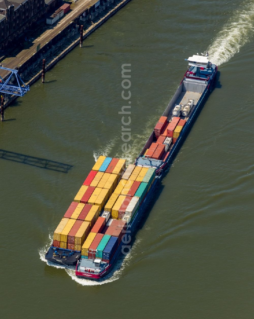 Duisburg from the bird's eye view: Sailing container ship at the Rhein in Duisburg in the state North Rhine-Westphalia