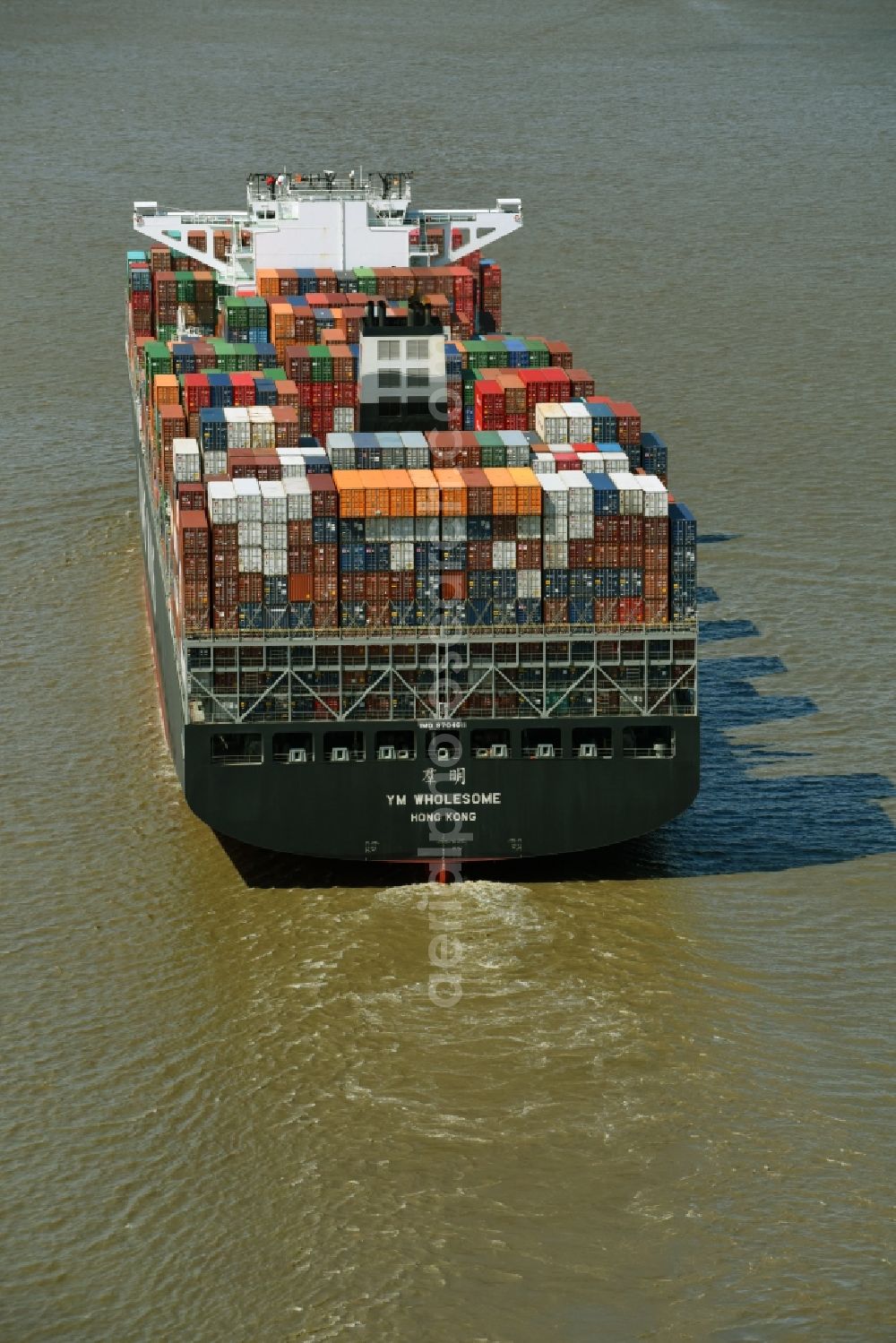 Aerial image Bützfleth - Sailing container ship YANG MING on river Elbe near Buetzfleth in the state Lower Saxony, Germany