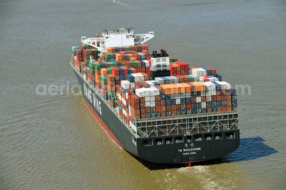 Aerial photograph Bützfleth - Sailing container ship YANG MING on river Elbe near Buetzfleth in the state Lower Saxony, Germany