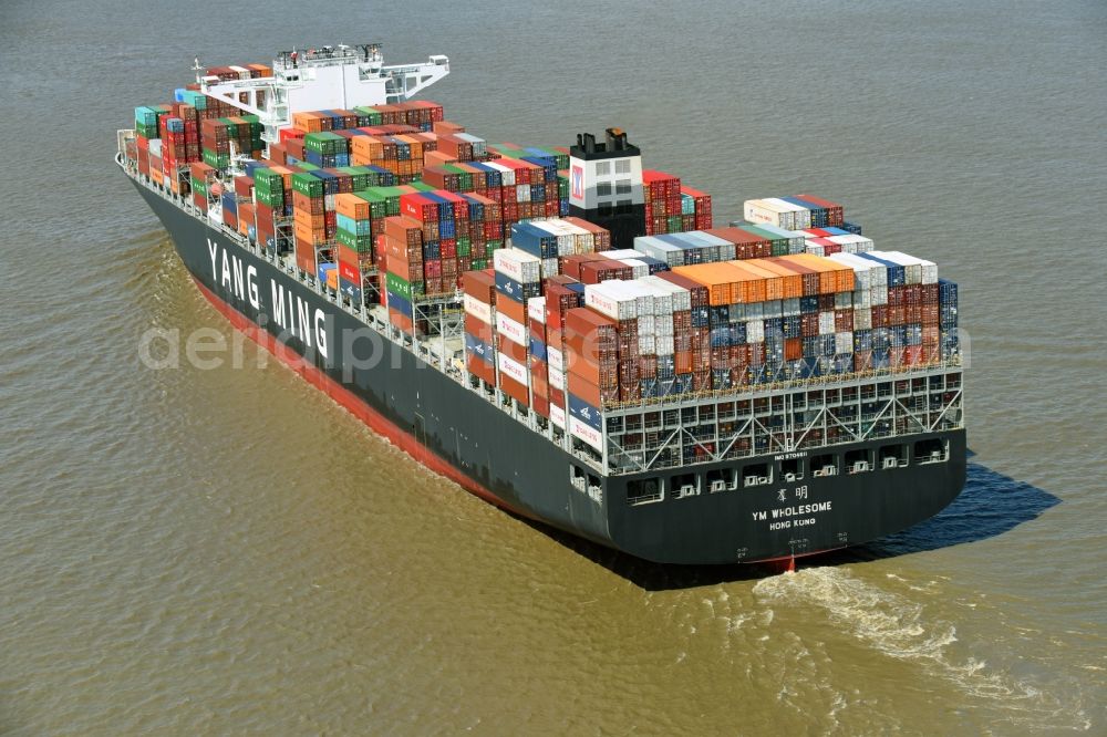 Bützfleth from above - Sailing container ship YANG MING on river Elbe near Buetzfleth in the state Lower Saxony, Germany