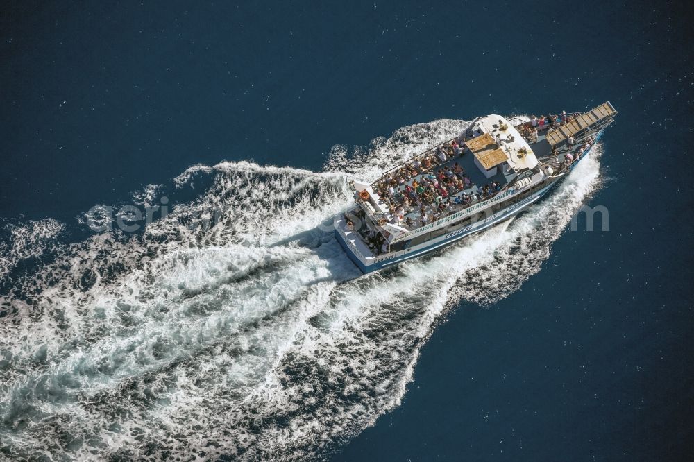 Roses from above - Passenger boat - Ferry in the coastal waters of the Mediterranean Sea against Roses in Spain