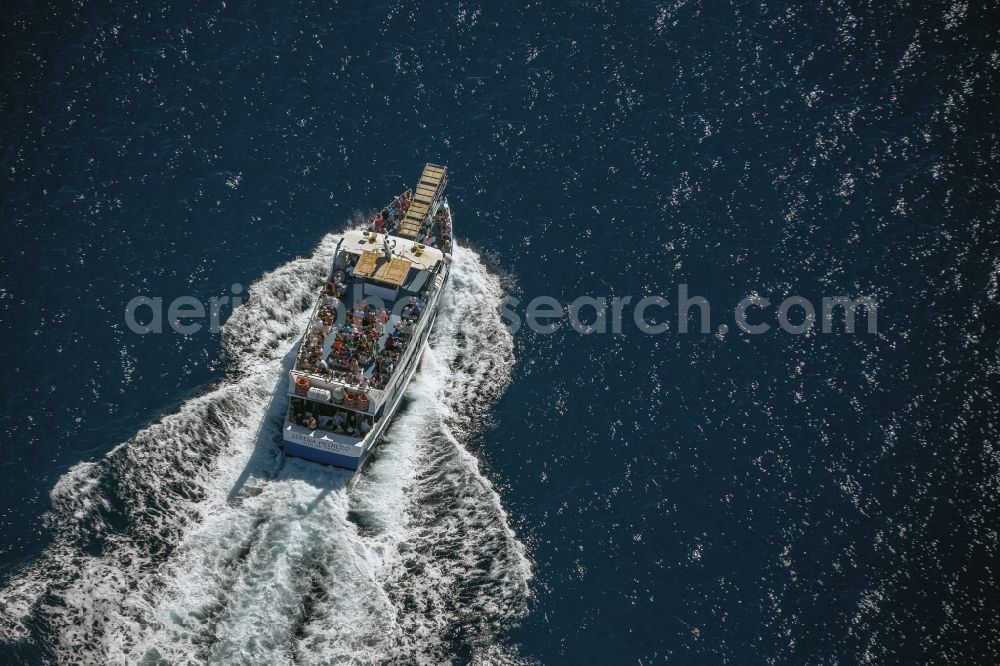 Roses from above - Passenger boat - Ferry in the coastal waters of the Mediterranean Sea against Roses in Spain