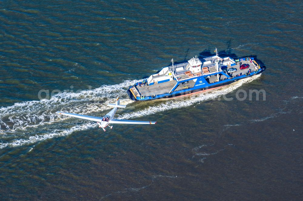 Bremerhaven from the bird's eye view: Travel of a ferry ship over the Weser and Geest estuary with a flyover of a C 25 Falken in Bremerhaven in the state of Bremen, Germany