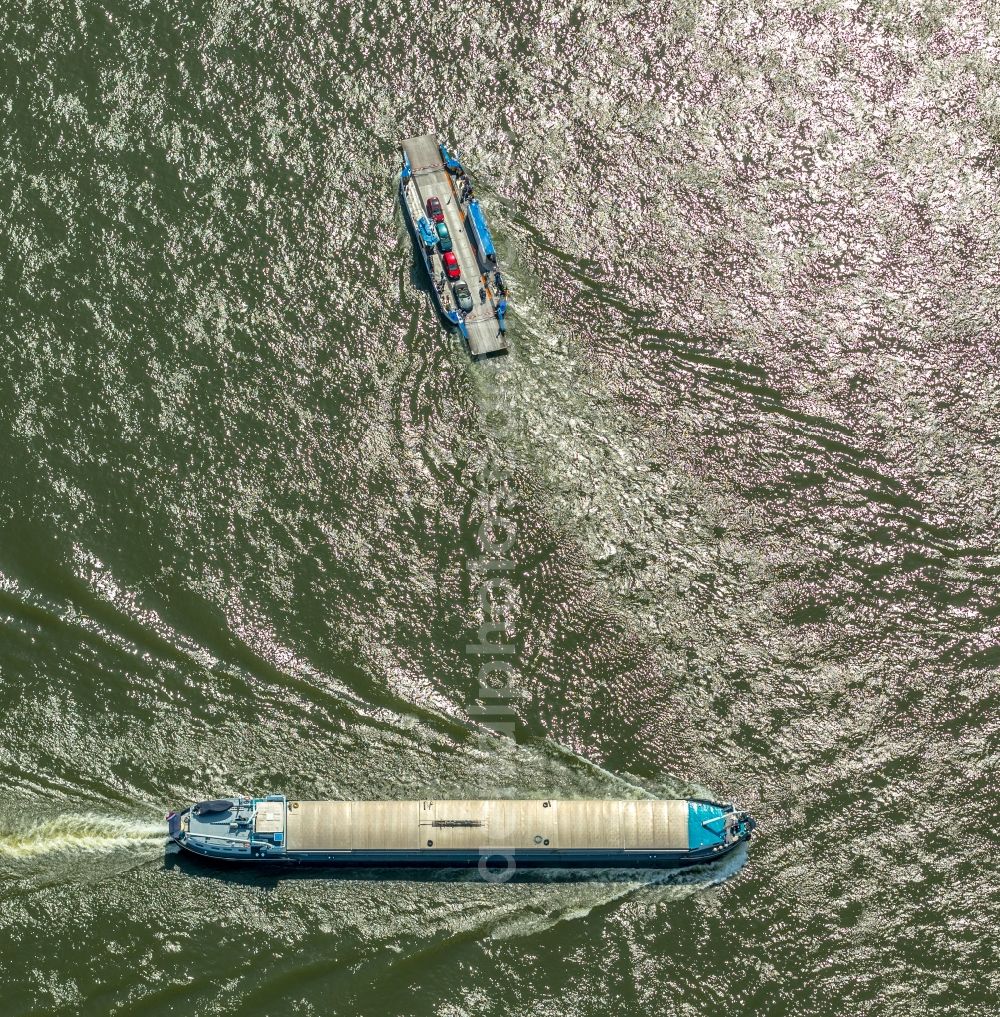 Aerial image Orsoy - Ride a ferry ship and eines Schuettgutfrachters on Rhein in Orsoy in the state North Rhine-Westphalia, Germany