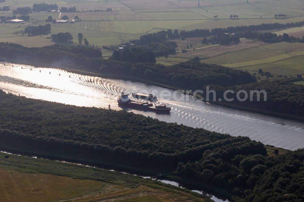 Aerial photograph Kudensee - Ride of freight ships in Nord-Ostsee-Kanal in Kudensee in the state Schleswig-Holstein, Germany