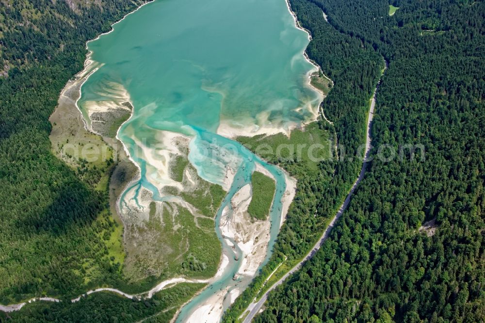 Lenggries from the bird's eye view: Play of colors on the river delta of Sylvenstein lake in Isarwinkel at Vorderriss in Bavaria, Germany. The Sylvensteinsee is a reservoir of Isar, Duerrach and Walchen built for flood protection in the Isar valley. Hydropower plants at the dam are used for power generation