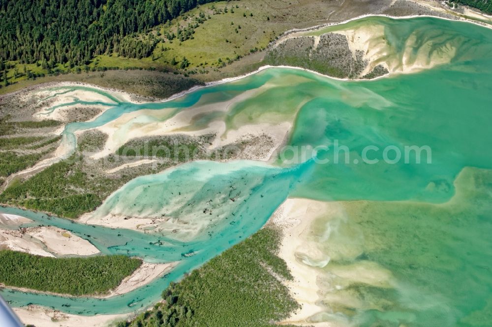 Lenggries from above - Play of colors on the river delta of Sylvenstein lake in Isarwinkel at Vorderriss in Bavaria, Germany. The Sylvensteinsee is a reservoir of Isar, Duerrach and Walchen built for flood protection in the Isar valley. Hydropower plants at the dam are used for power generation