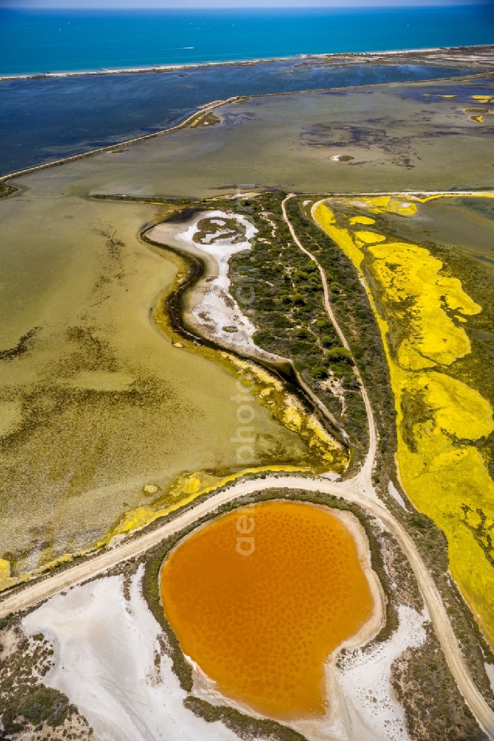 Aerial image Saintes-Maries-de-la-Mer - Colored Salinen- landscape in Saintes-Maries-de-la-Mer in France