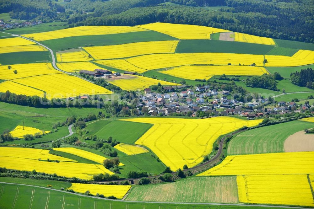 Aerial image Grävenwiesbach - Field landscape yellow flowering rapeseed flowers in Graevenwiesbach in the state Hesse