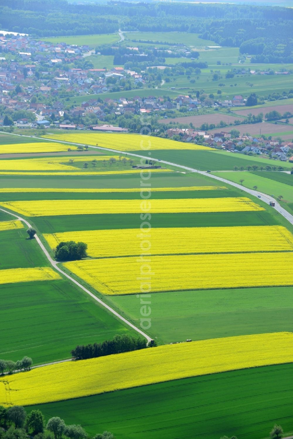 Aerial image Karbach - Field landscape yellow flowering rapeseed flowers in Karbach in the state Bavaria