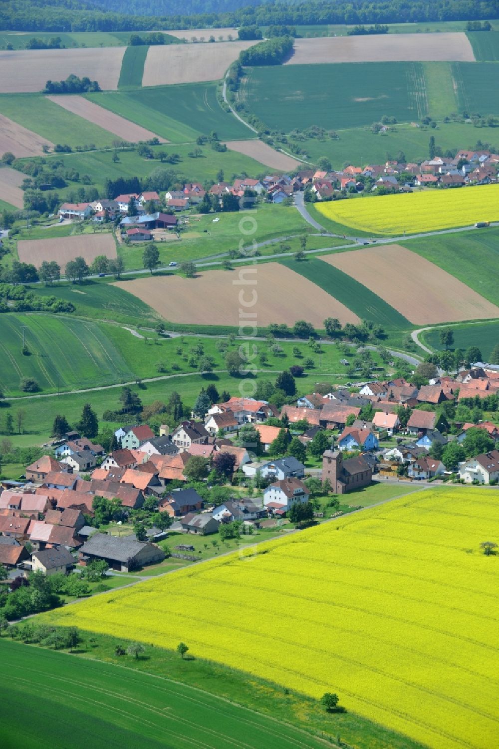 Aerial image Karbach - Field landscape yellow flowering rapeseed flowers in Karbach in the state Bavaria