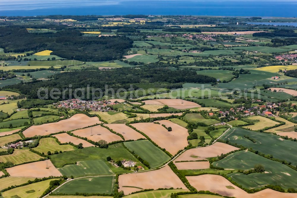 Klamp from above - Agricultural fields with adjacent forest and forest areas in Klamp in the state Schleswig-Holstein, Germany