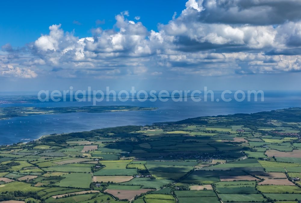 Aerial image Munkbrarup - Landscape of mainly agricultural fields with adjoining forest and forest areas in Munkbrarup in the state Schleswig-Holstein, Germany. View over the Flensburg Fjord to southern Denmark