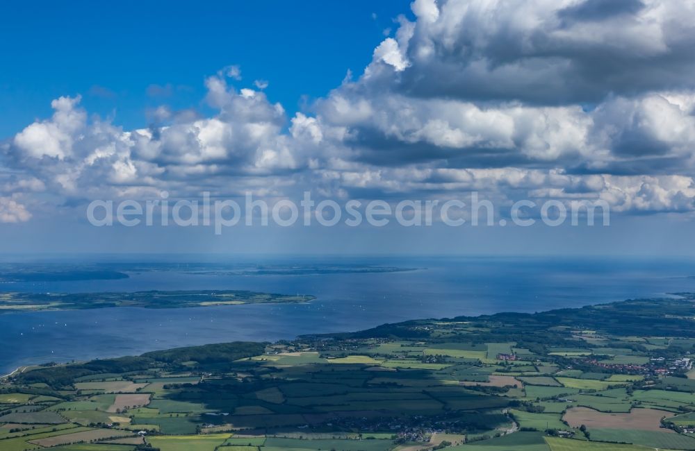 Munkbrarup from the bird's eye view: Landscape of mainly agricultural fields with adjoining forest and forest areas in Munkbrarup in the state Schleswig-Holstein, Germany. View over the Flensburg Fjord to southern Denmark