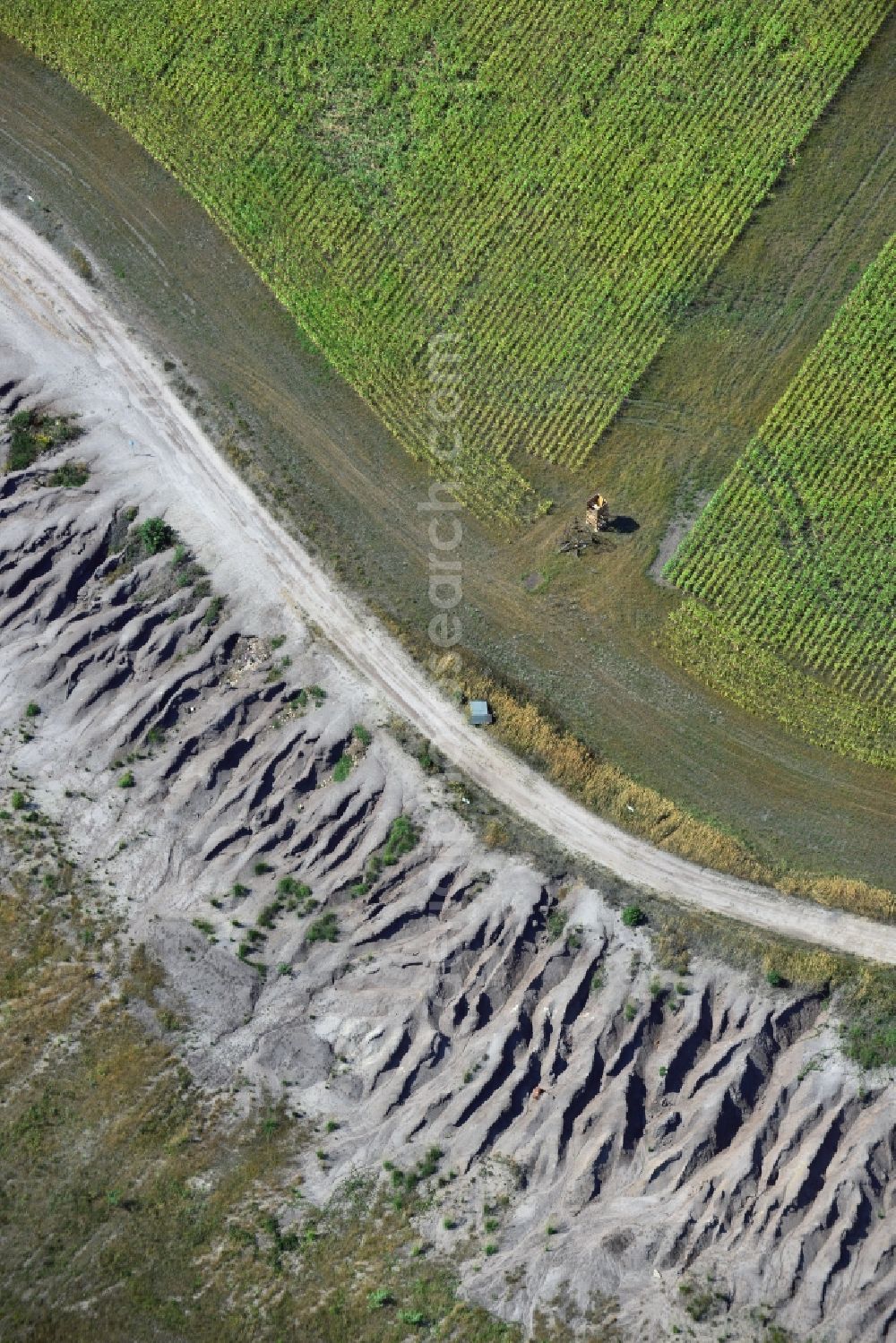 Grünewalde from the bird's eye view: Field edge to the slag heap of brown coal mining - mining landscape near Gruenwalde in Brandenburg