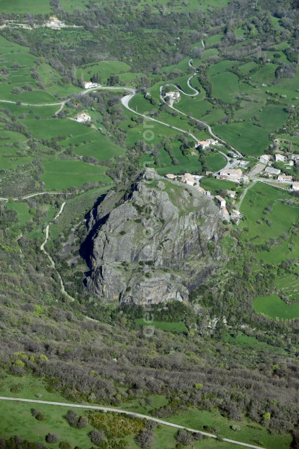 Sceautres from the bird's eye view: Rock and mountain landscape with the basalt rock Neck de Sceautres in the village of Sceautres in Auvergne Rhone-Alpes, France