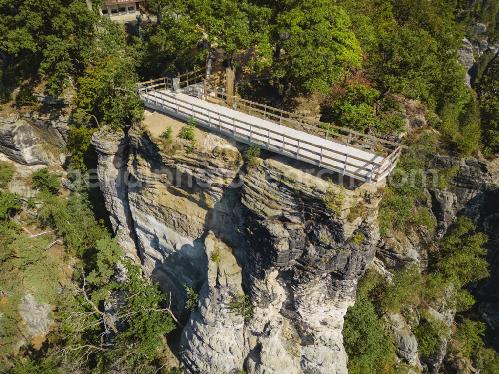 Lohmen from the bird's eye view: Rock massif and mountain landscape with the Bastei viewpoint - platform on the Basteiweg road in Lohmen, Elbe Sandstone Mountains in the state of Saxony, Germany