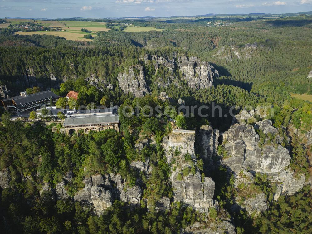 Lohmen from above - Rock massif and mountain landscape with the Bastei viewpoint - platform on the Basteiweg road in Lohmen, Elbe Sandstone Mountains in the state of Saxony, Germany