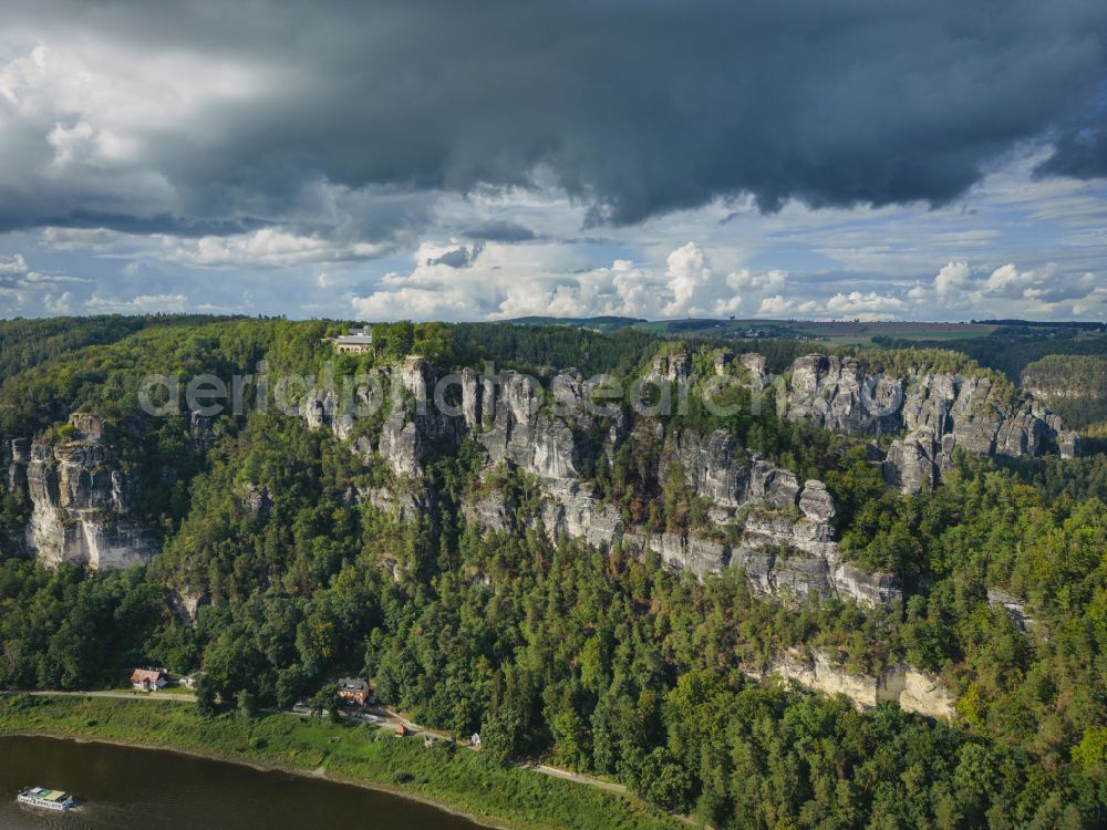 Lohmen from the bird's eye view: Rock massif and mountain landscape with the Bastei viewpoint - platform on the Basteiweg road in Lohmen, Elbe Sandstone Mountains in the state of Saxony, Germany