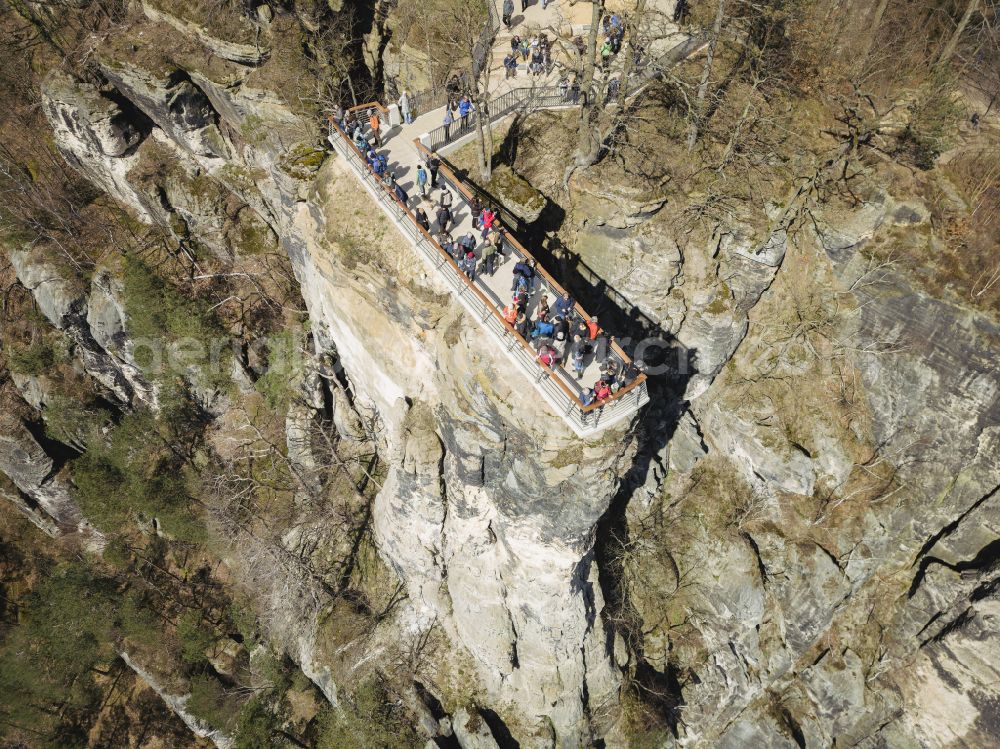 Lohmen from the bird's eye view: Rock massif and mountain landscape with the Bastei viewpoint - platform on the Basteiweg road in Lohmen, Elbe Sandstone Mountains in the state of Saxony, Germany