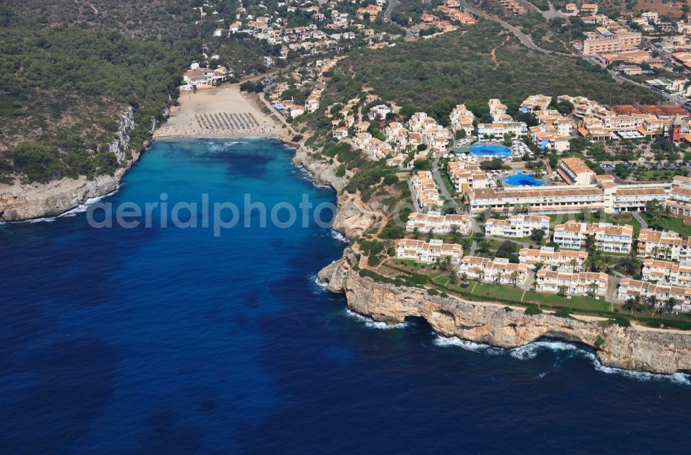 Aerial image Cala s'Estany d'en Mas - Coastline on the sandy beach of Cala Romantica at Cala s'Estany d'en Mas at Porto Christo in Mallorca in Balearic Islands, Spain