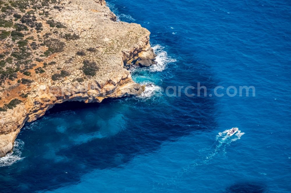 Aerial image Manacor - Rock Coastline on the cliffs with Hoehle and Strand Cala Bota in Manacor in Islas Baleares, Spain