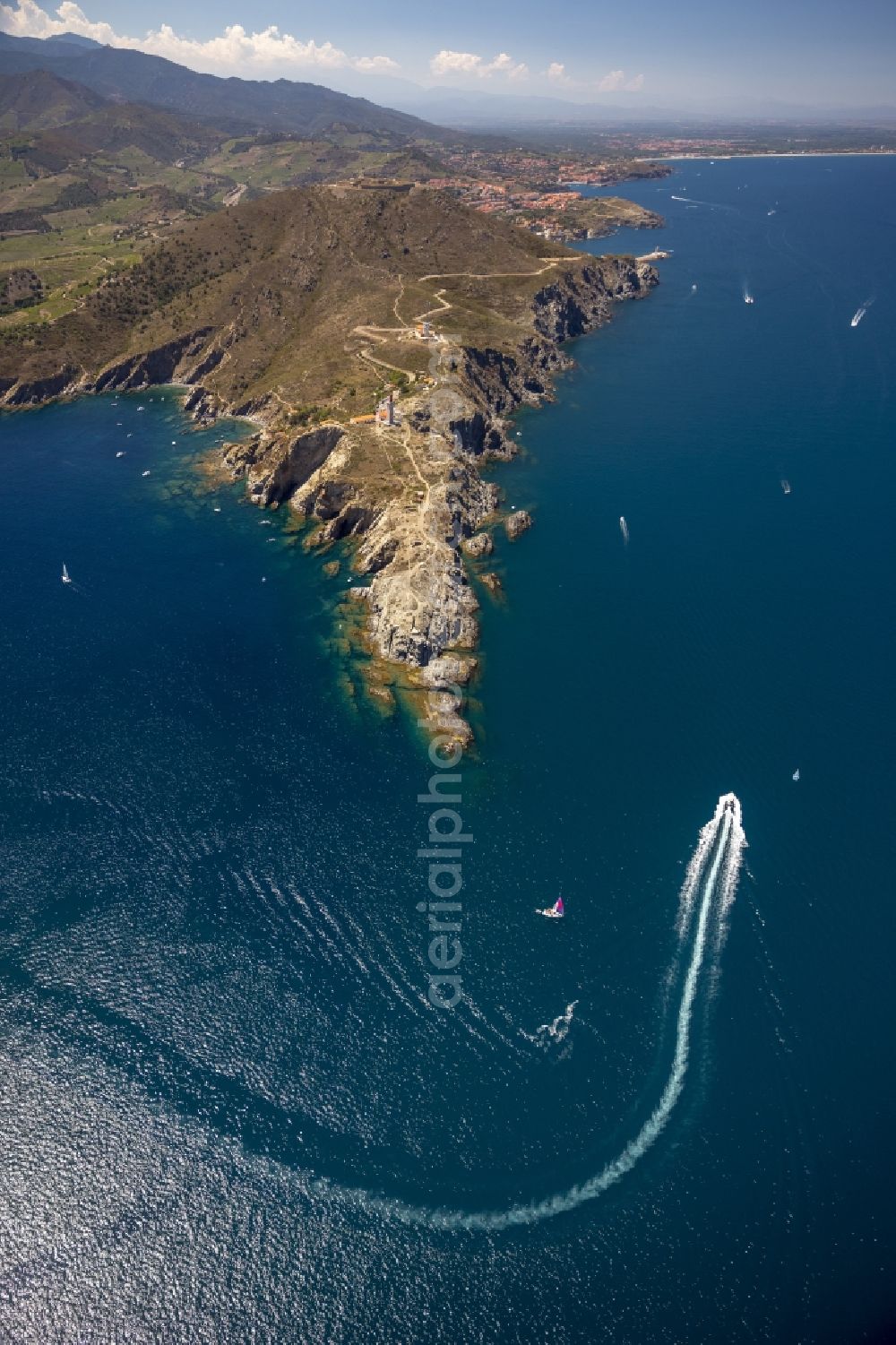 Port-Vendres from the bird's eye view: Crags Bear Cap with lighthouse on the Mediterranean coast in Port-Vendres in the province of Languedoc-Roussillon in France