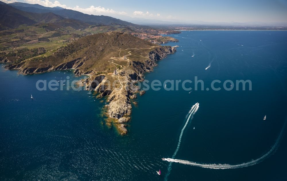 Port-Vendres from the bird's eye view: Crags Bear Cap with lighthouse on the Mediterranean coast in Port-Vendres in the province of Languedoc-Roussillon in France