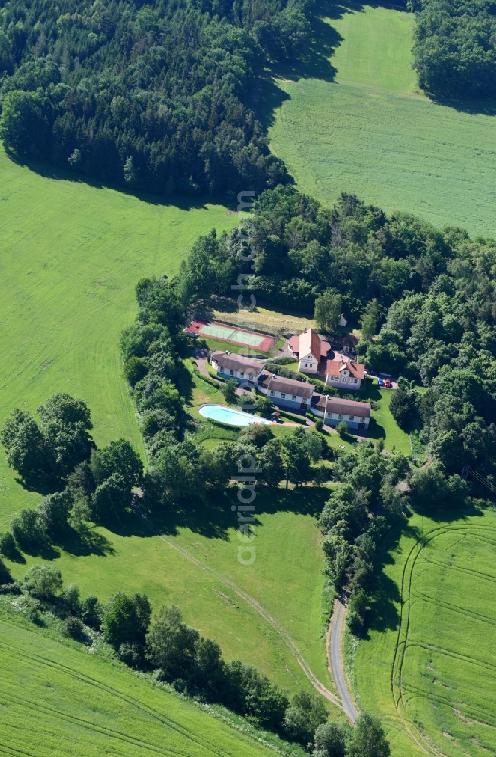 Hradiste from the bird's eye view: Small summer cottage arrangement with sports field and swimming pool in Hradiste in Plzensky kraj - Pilsner region - Bohemia, Czechia