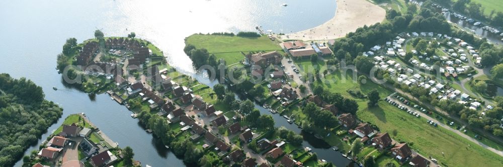 Großefehn from the bird's eye view: Holiday house plant of the park at the lake timmeler sea with a bathing beach and meadows in Grossefehn in the state Lower Saxony