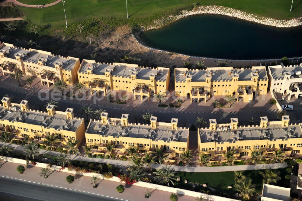 Ras Al Khaimah from the bird's eye view: Settlement of leisure residences near the Al Hamra Golf Club in the arab emirate Ras Al Khaimah. The leisure residences are part of the Al Hamra Village Project, the second largest construction project of Ras Al Khaimah. The project is realized by the state-owned company Al Hamra Real Estate