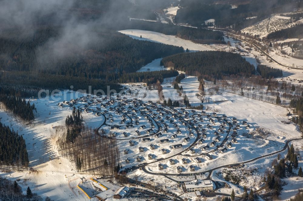 Aerial photograph Winterberg - View of the partially snow covered foggy and cloudy landscape of the Landal Holiday park in the state North Rhine-Westphalia