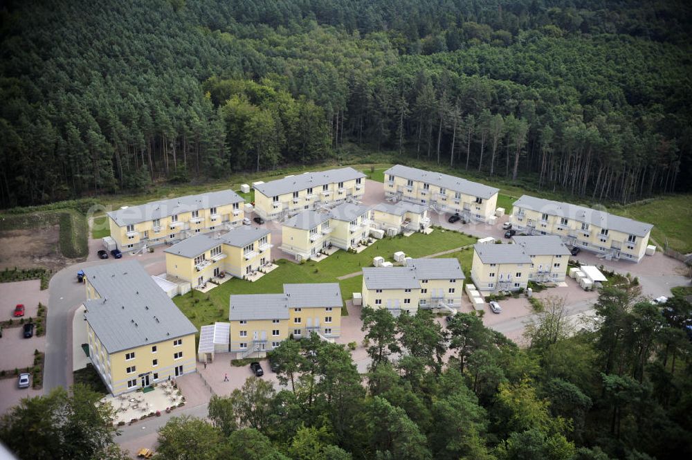 Graal-Müritz from the bird's eye view: Blick auf den Ferienwohnpark im Küstenwald der HAWO Bauträger KG in unmittelbarer Strandnähe im Ostseeheilbad Graal-Müritz. Aus einer ehemaligen NVA Liegenschaft entstanden attraktive Ferienhäuser und Ferienwohneinheiten zum Verkauf und zur Vermietung. View of the coastal forest of the housing estate developers HAWO KG near the beach in the spa town of Graal Müritz.