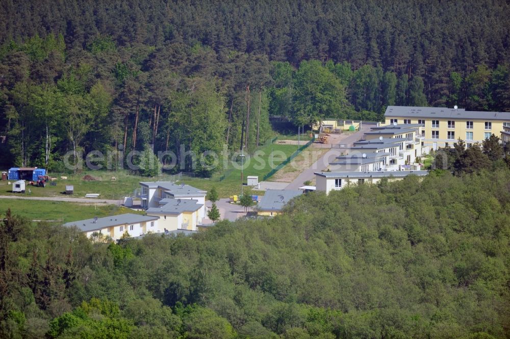 Seeheilbad Graal-Müritz from the bird's eye view: Blick auf den Ferienwohnpark im Küstenwald der HAWO Bauträger KG in unmittelbarer Strandnähe im Ostseeheilbad Graal-Müritz. Aus einer ehemaligen NVA Liegenschaft entstanden bisher in zwei Bauabschnitten attraktive Ferienhäuser und Ferienwohneinheiten zum Verkauf und zur Vermietung. View of the coastal forest of the housing estate developers HAWO KG near the beach in the spa town of Graal Müritz.